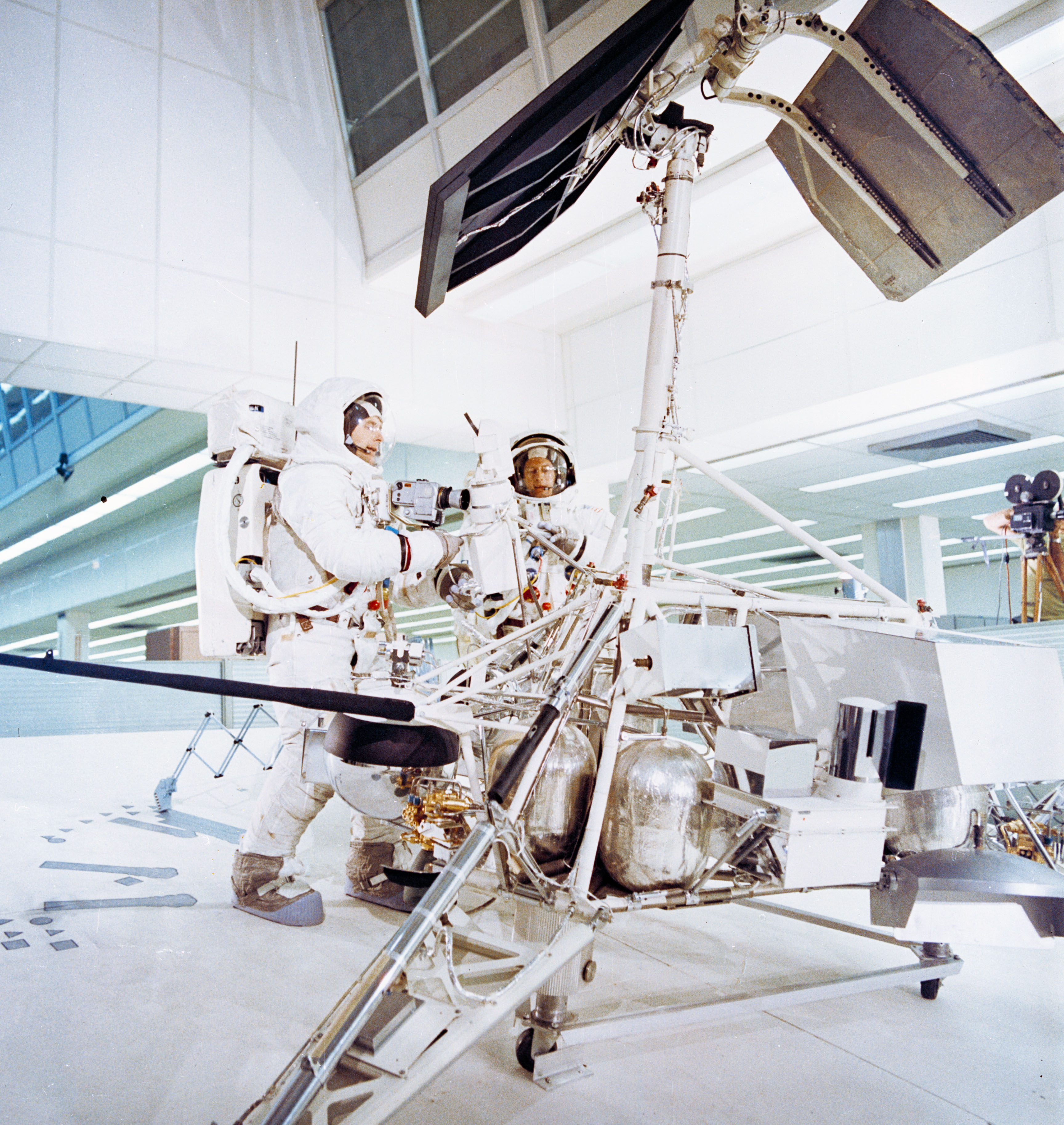 Bean, left, and Conrad train with an engineering model of a Surveyor spacecraft