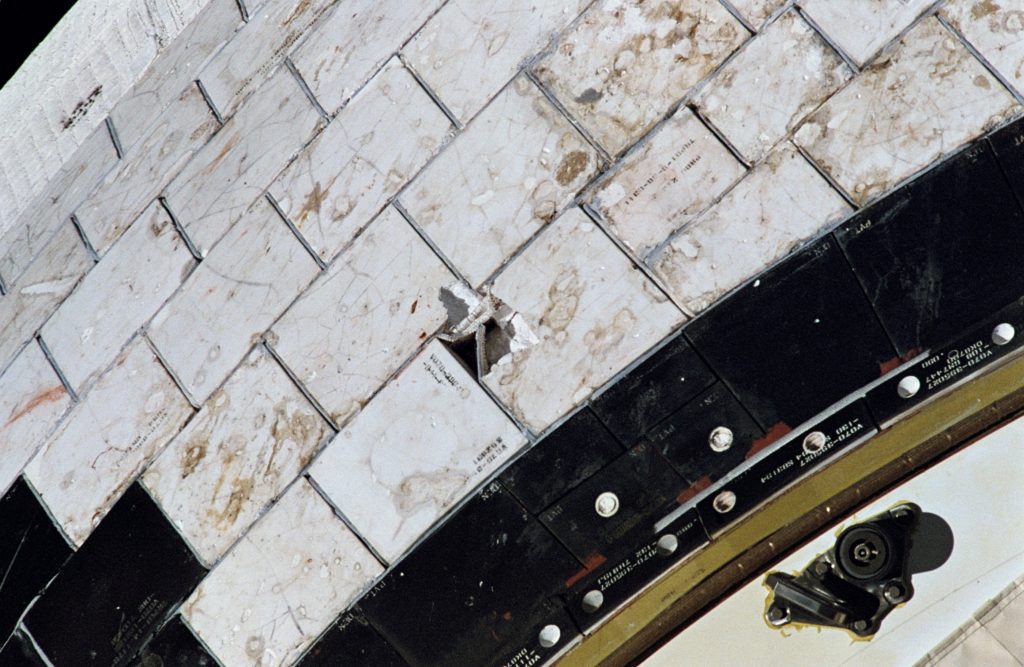 Tile damage on Endeavour’s starboard Orbital Maneuvering System pod caused by a strike from a tile from Endeavour’s front window rim that came loose during the ascent