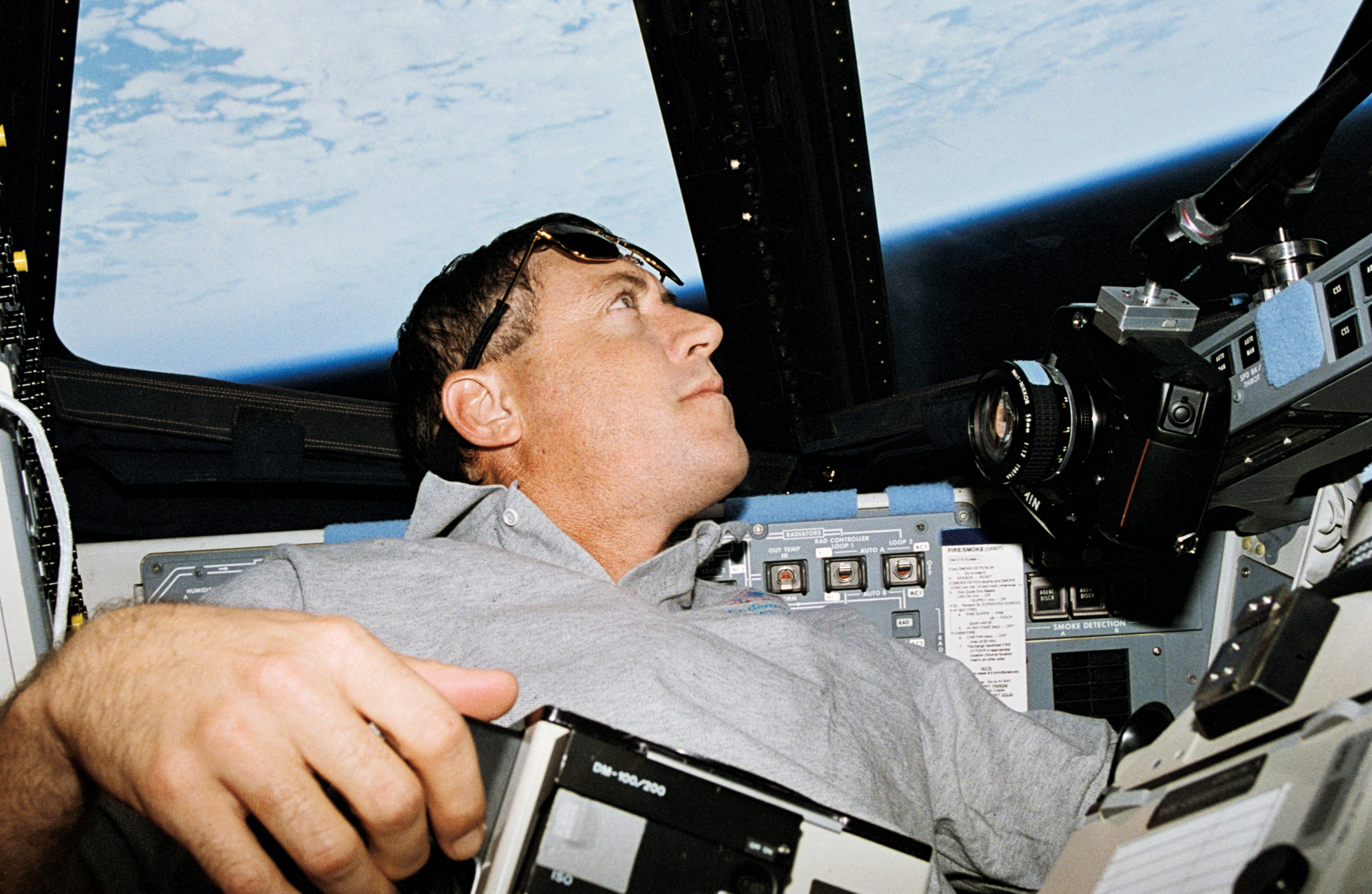 Michael A. Baker prepares to take photographs through the commander's window