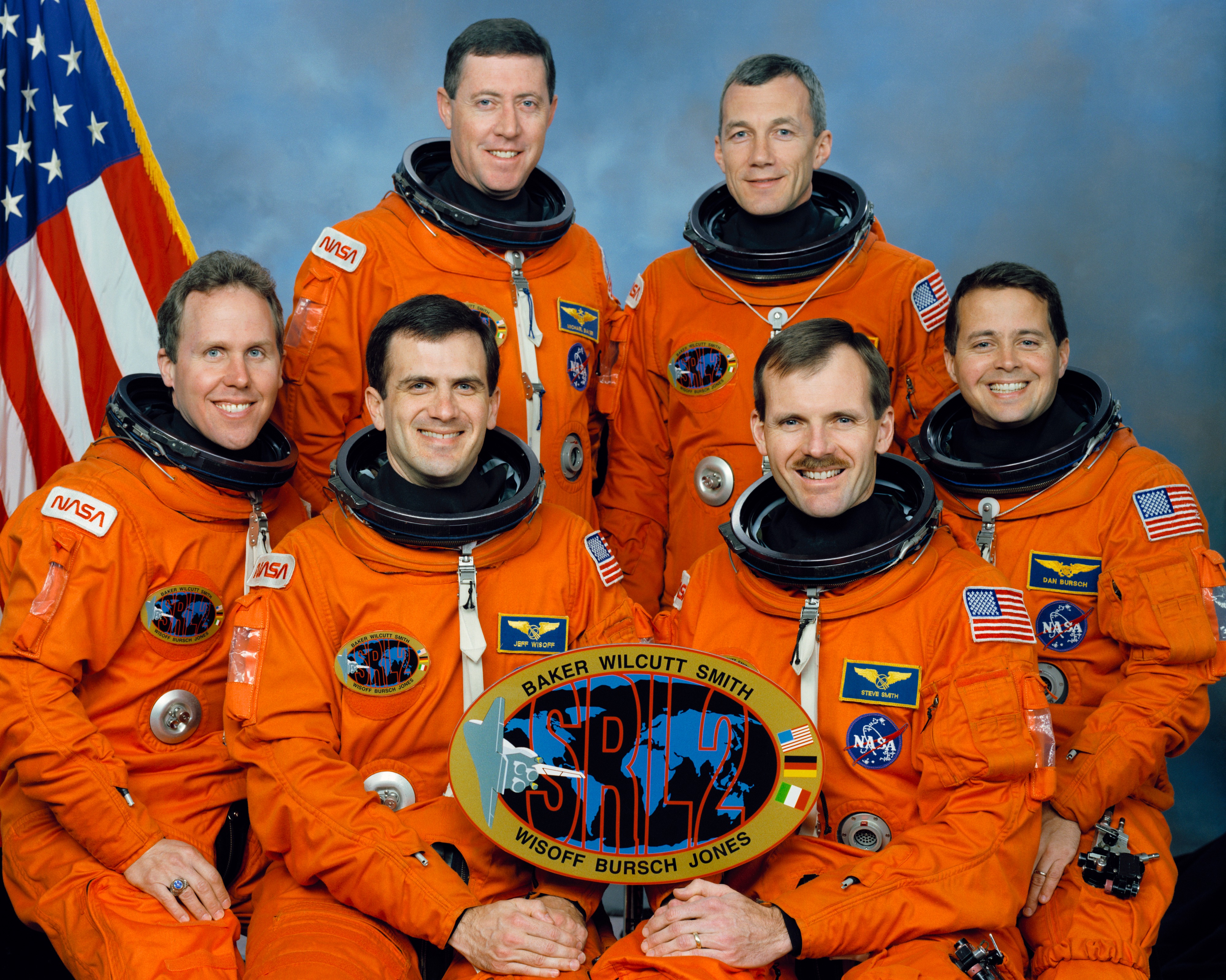 Official photo of the STS-68 crew of Thomas D. Jones, front row left, Peter J.K. “Jeff” Wisoff, Steven L. Smith, and Daniel W. Bursch; Michael A. Baker, back row left, and Terrence W. Wilcutt