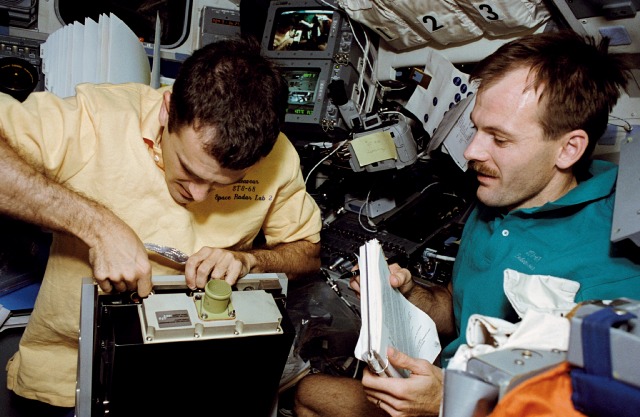 Peter J.K. “Jeff” Wisoff, left, and Smith repair a payload high rate recorder