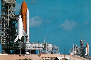 space shuttle Discovery arrives at Launch Pad 39B, left, with space shuttle Endeavour still on Launch Pad 39A, awaiting its rollback to the Vehicle Assembly Building