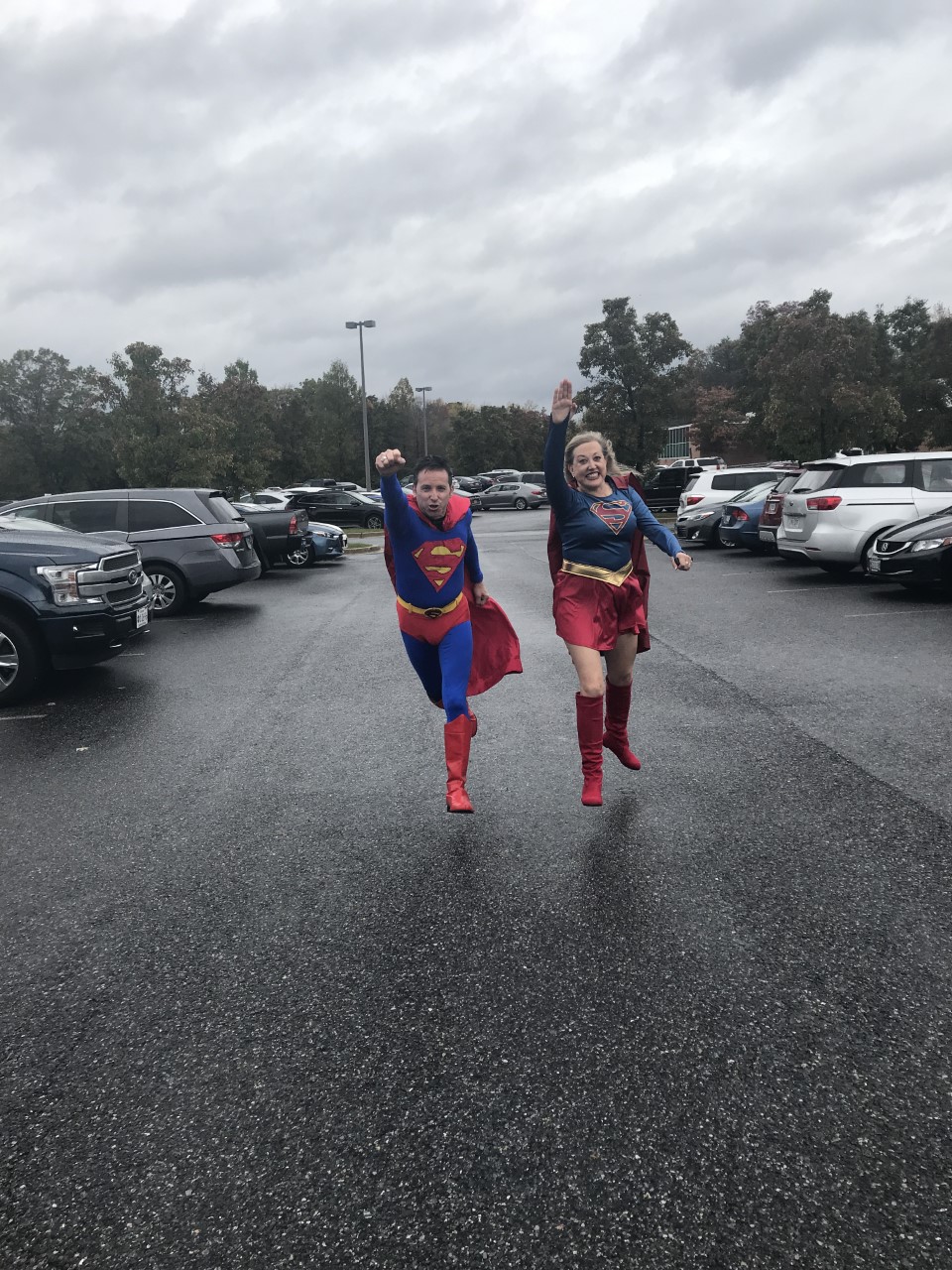 Rob Gutro and Lynn Jenner dressed as superheroes