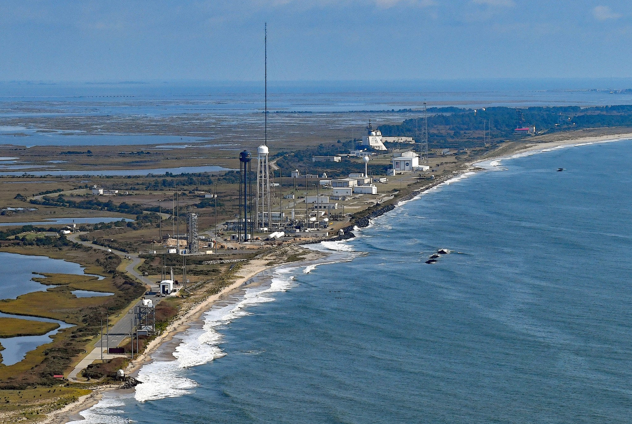 Aerial view of NASA's Wallops Flight Facility's launch range structures along the coastline of Wallops Island, Virginia. Ocean, bay and marsh lands surround the range.