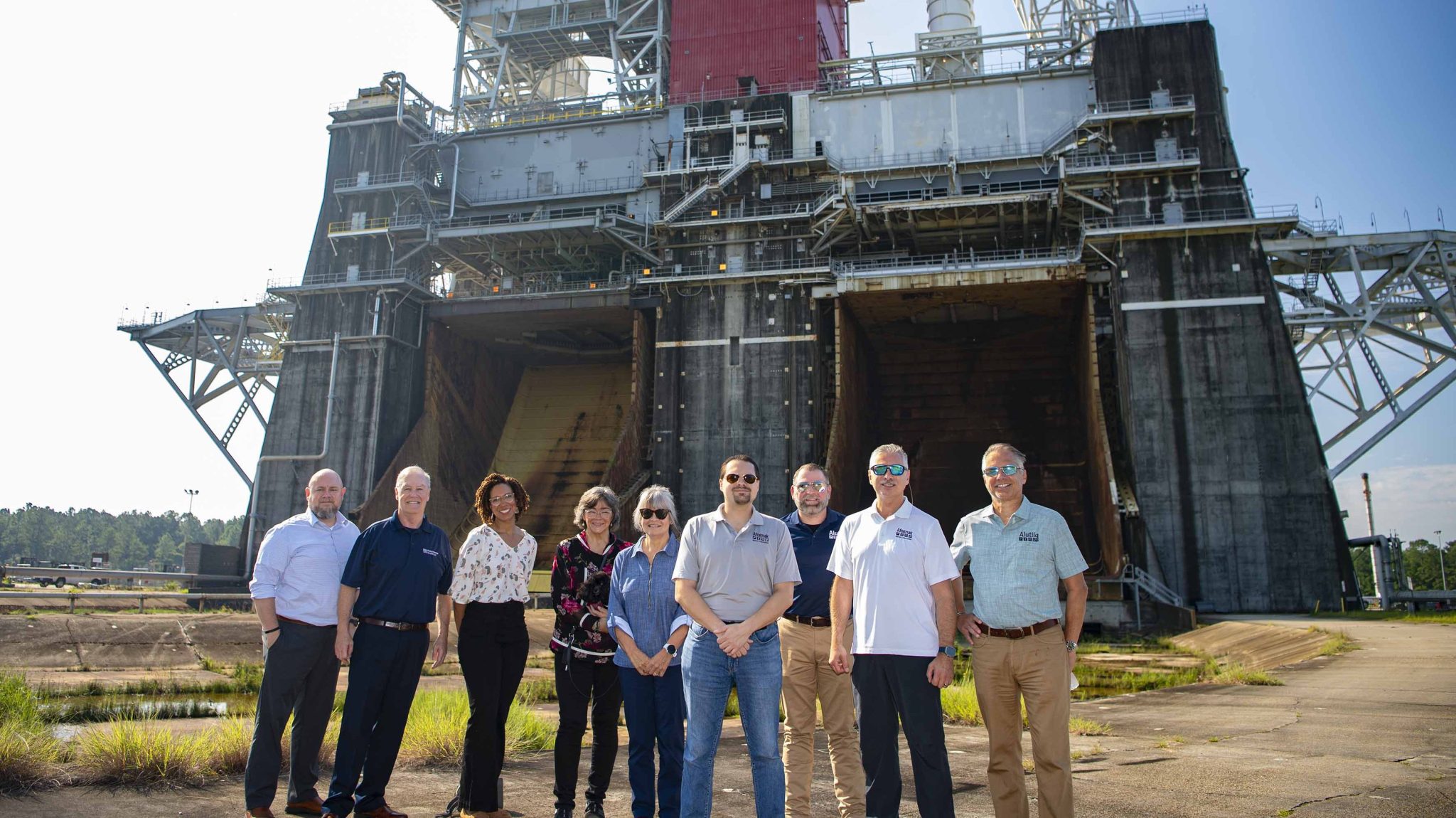 Afognak Native Corporation Board of Director members and Alutiiq, LLC executives stand at the Thad Cochran Test Stand