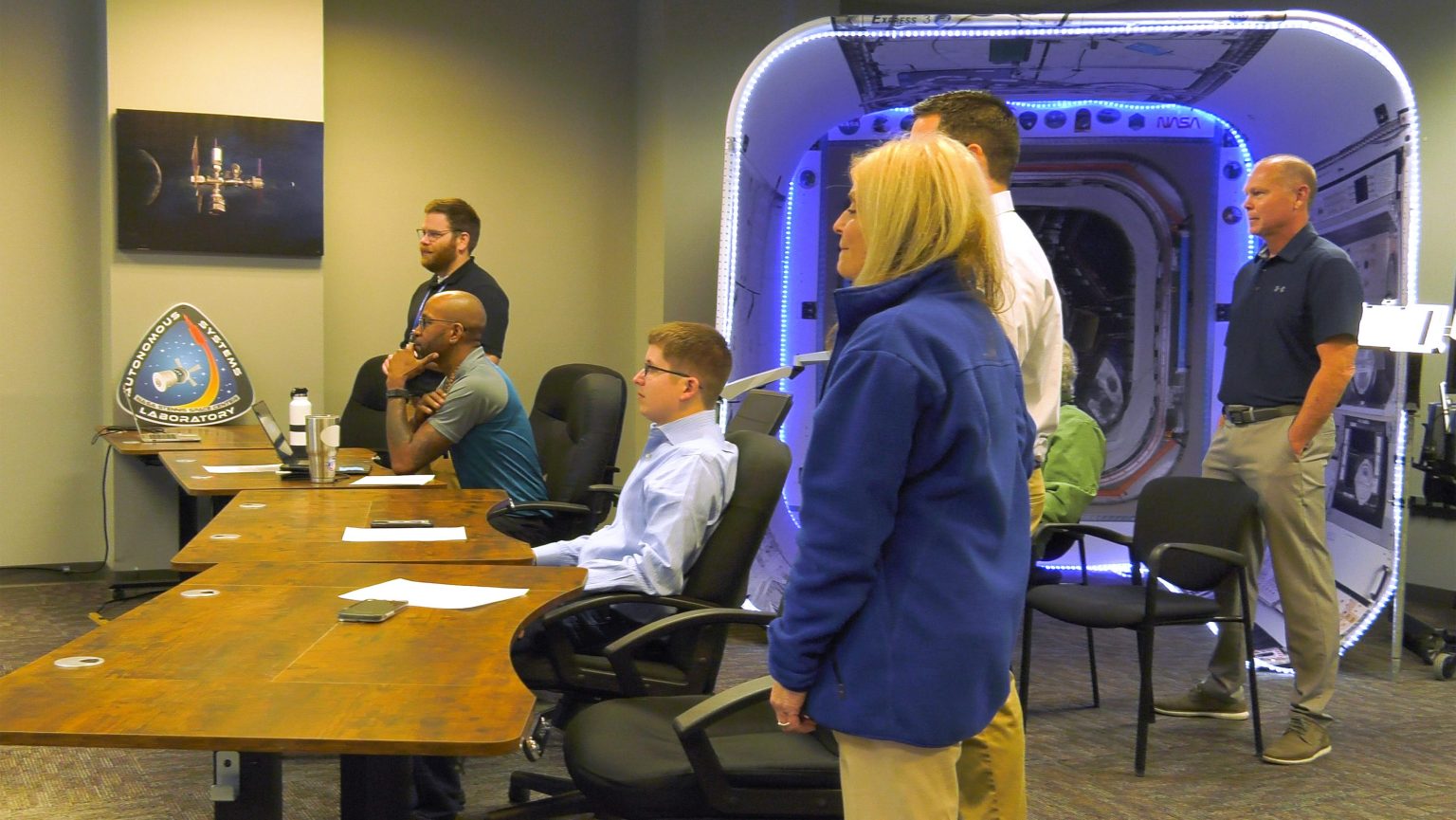 The NASA Stennis Autonomous Systems Laboratory team and John Bailey, then acting center director of NASA Stennis, are shown at NASA's Stennis Space Center watching the launch of the Sidus Space LizzieSat-1 (LS-1) small satellite into space