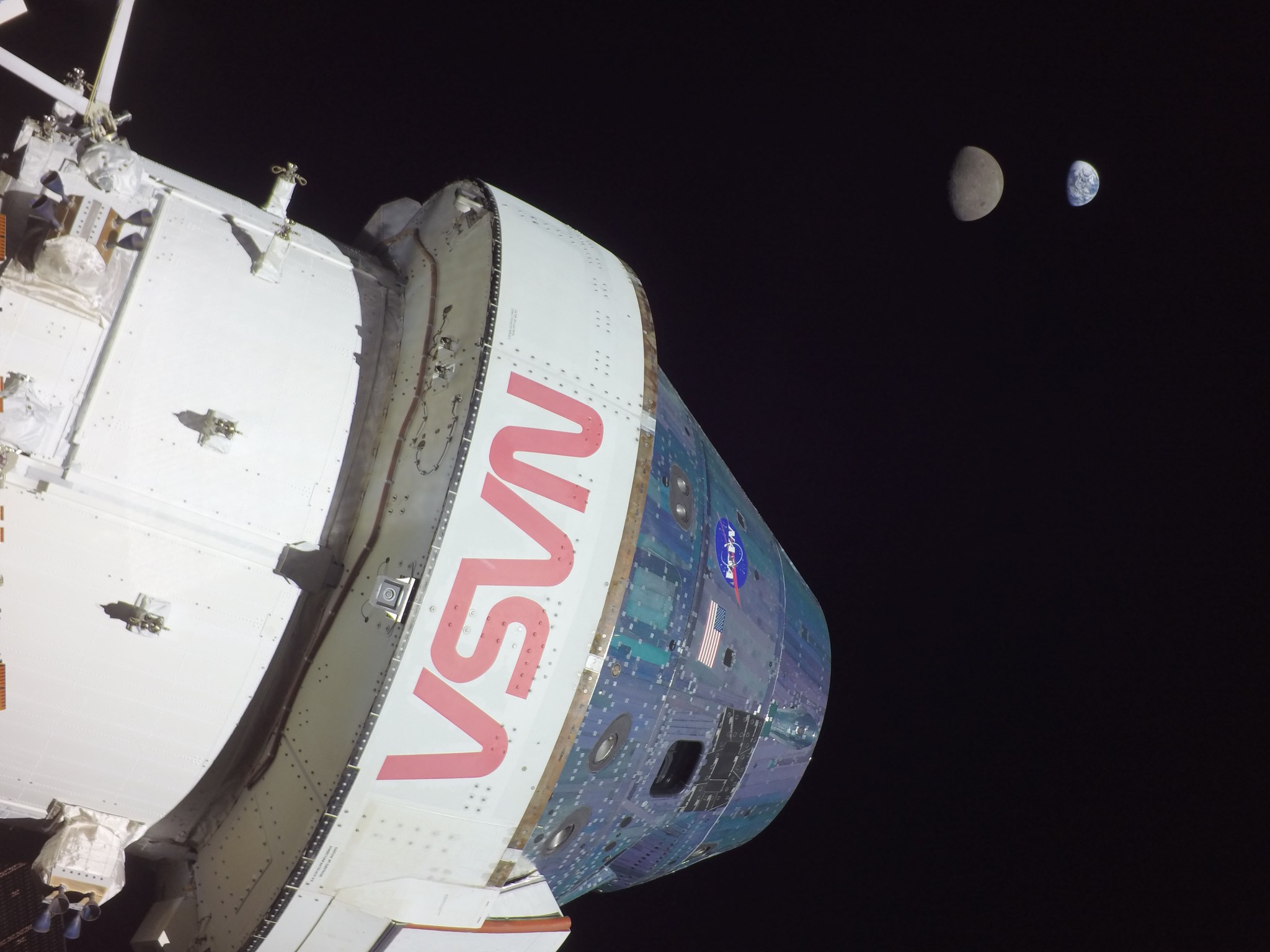 Orion capsule in transit with the Moon and Earth in the distant background.