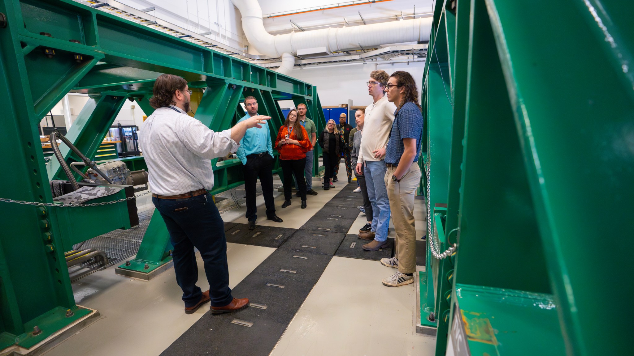 Blake Stewart, lead of the Thrust Vector Control Test Laboratory inside Building 4205 at NASA’s Marshall Space Flight Center, explains how his team tests the mechanisms that steer engine and booster nozzles of NASA’s SLS (Space Launch System) rocket to a group of Marshall team members Oct. 24. The employees were some of the more than 500 team members who viewed progress toward future Artemis flights on bus tours offered by the SLS Program. Building 4205 is also home to the Propulsion Research and Development Laboratory that includes 26 world-class labs and support areas that help the agency’s ambitious goals for space exploration. The Software Integration Lab and the Software Integration Test Facility are among the labs inside supporting SLS that employees visited on the tour.