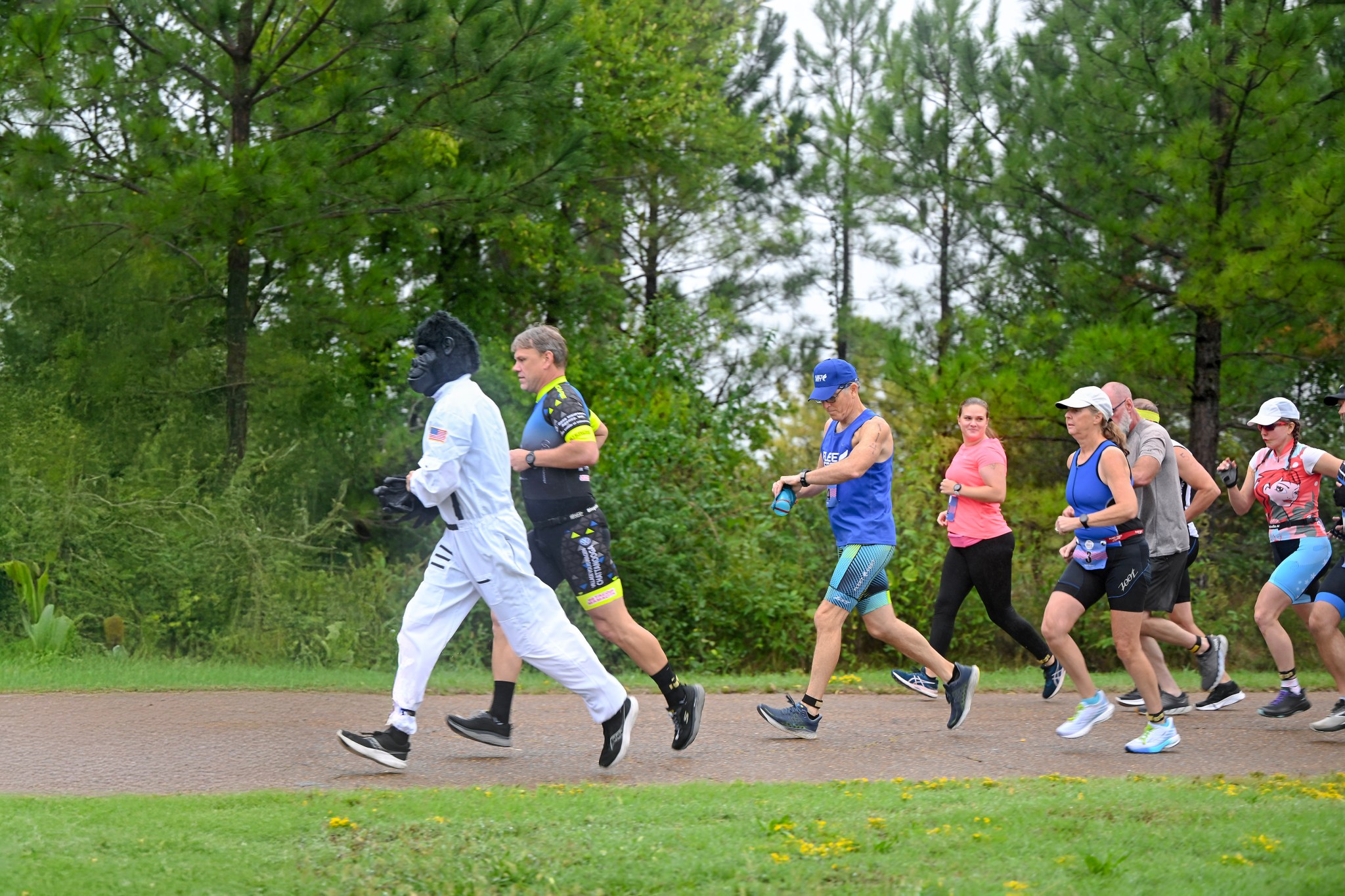 A costumed gorilla pacer leads a group of runners during “Racin’ the Station” duathlon, a run/bike/run event where the participants “raced” the International Space Station. The event was Sept. 28 at NASA’s Marshall Space Flight Center, which is on Redstone Arsenal. “Racin’ the Station” is an annual event where participants try to complete the course faster than it takes the space station to complete one Earth orbit, which is every 91 minutes, 12 seconds. Organizers track the starting location of the space station at the race start, and a costumed pacer keeps up with the station time on the course as a visual marker for participants to stay ahead of. Before the race, organizers drew a to-scale SLS (Space Launch System) Block 1 rocket in chalk onto the Activities Building parking lot near the race transition area. The opening ceremonies featured a video of the Artemis 1 launch, with the race starting with the launch of a model rocket. “The rain was a first for race day since we started this event in 2012,” said Kent Criswell, race organizer for Marshall. “But we still had a safe race with 106 individuals and 13 relay teams finishing.” The event is organized by the Team Rocket Triathlon Club in Huntsville and by the Marshall Association, a professional employee service organization at the Marshall Center whose members include civil service employees, retirees and contractors. Proceeds from the registration fee for the event go to the Marshall Association scholarship fund.