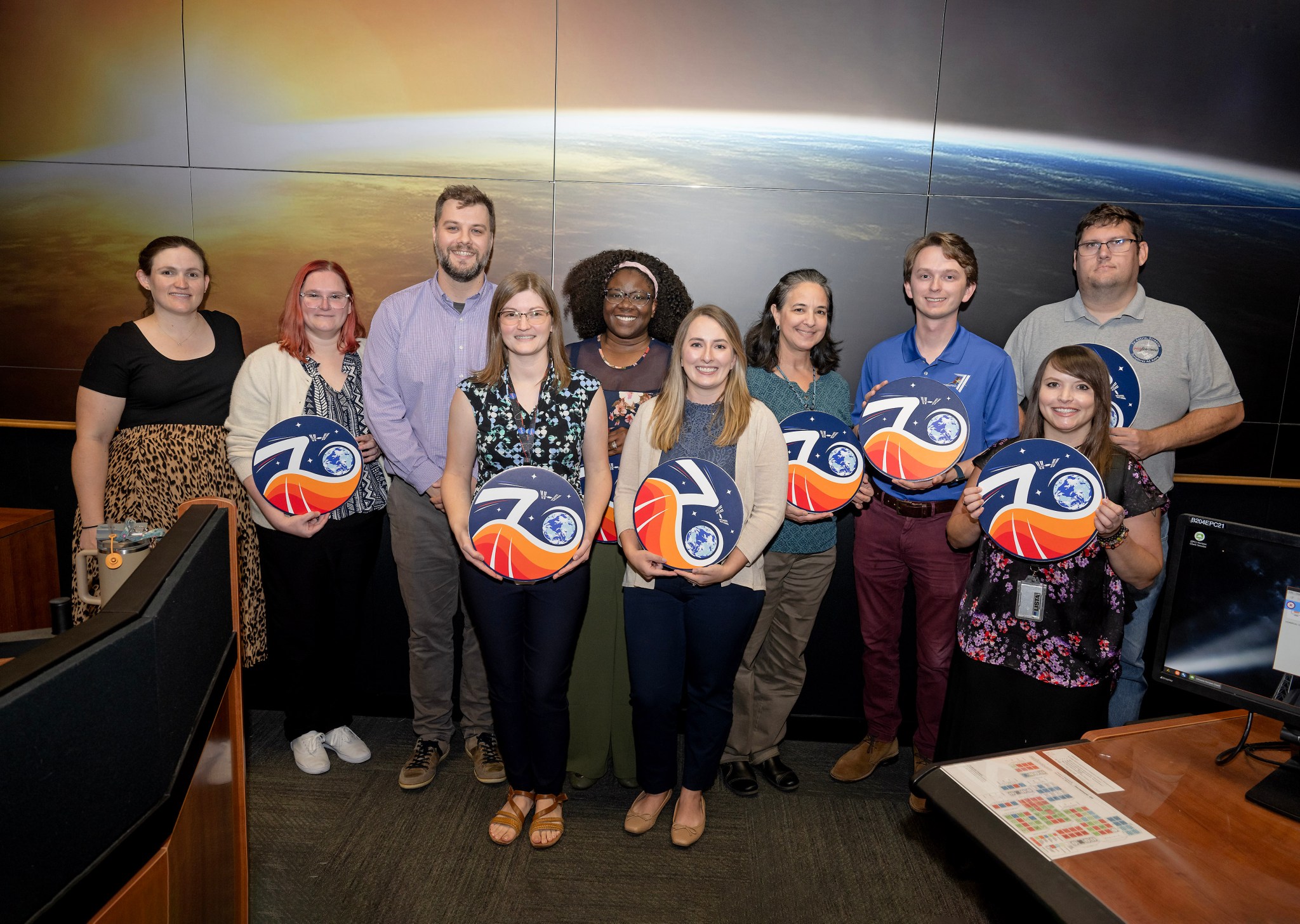 NASA’s Marshall Space Flight Center continued the tradition of honoring engineers for their exceptional efforts on Commercial Crew Program (CCP) missions to the International Space Station on Sept. 4, with a plaque hanging for Expedition 70 at the Huntsville Operations Support Center (HOSC). Holding their plaques are, from left, Shelby Bates, Ali Reilly, Chris Buckley, Mandy Clayton, Elease Smith, Sara Dennis, Stephanie Stoll, John Griffin, Kylie Keeton, and Blake Parker. Team members are nominated from Marshall, Johnson Space Center, and Kennedy Space Center to hang the plaque of the mission they supported. Expedition 70 – which ended April 5 – researched heart health, cancer treatments, space manufacturing techniques, and more during their long-duration stay in Earth orbit. The HOSC provides engineering and mission operations support for the space station, the CCP, and Artemis missions, as well as science and technology demonstration missions. The Payload Operations Integration Center within HOSC operates, plans, and coordinates the science experiments onboard the space station 365 days a year, 24 hours a day.