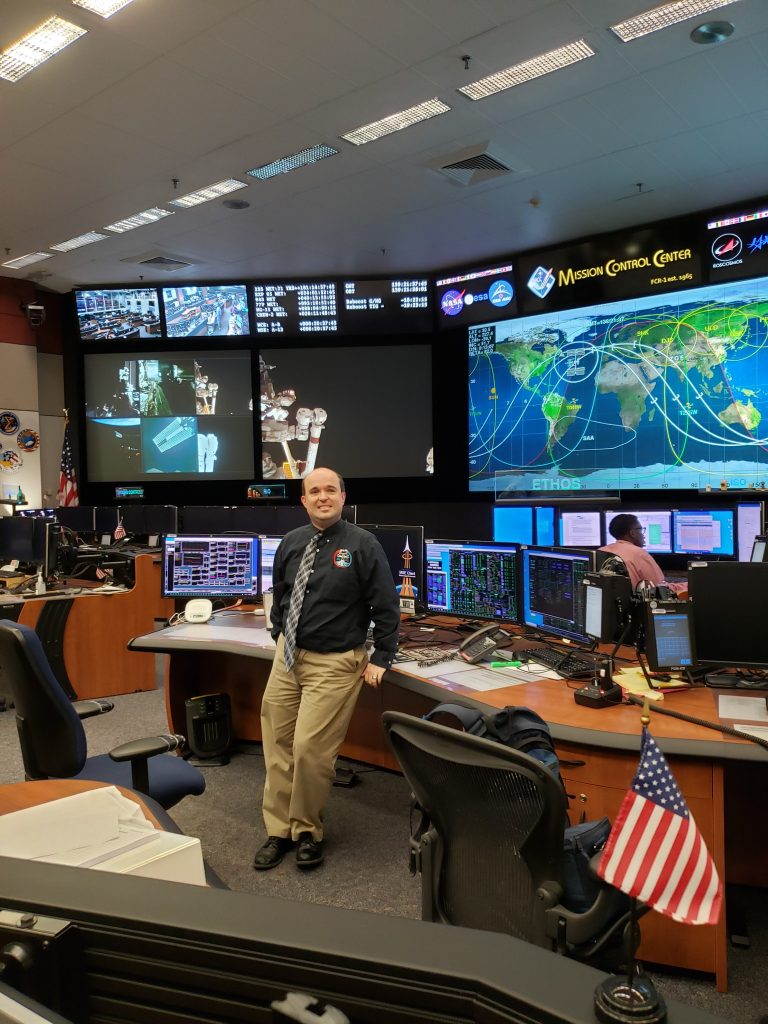 Jesse Bazley stands in the Mission Control Center during his final shift as a flight controller.