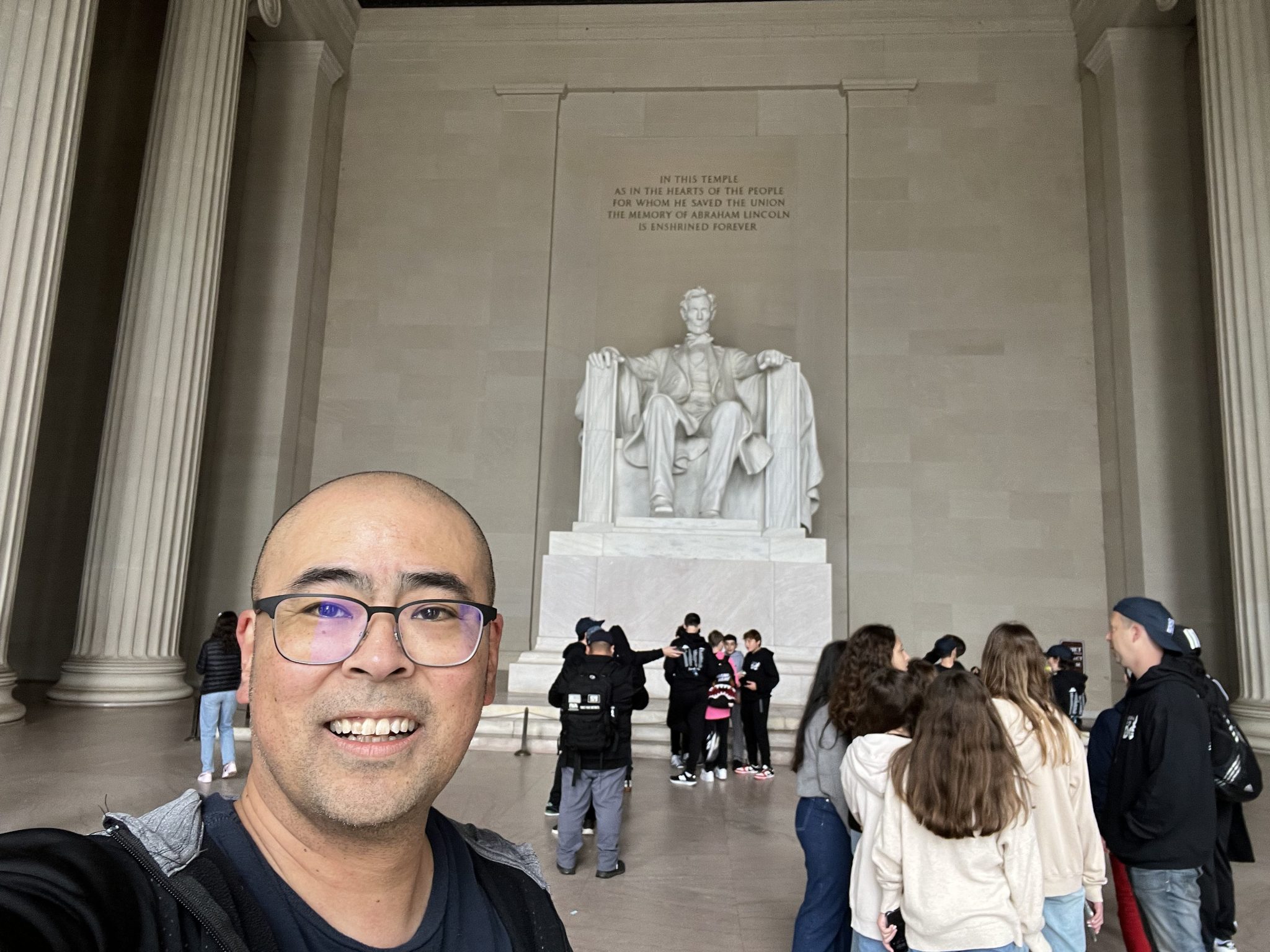 A man takes a selfie in front of the Lincoln Memorial in Washington, D.C.