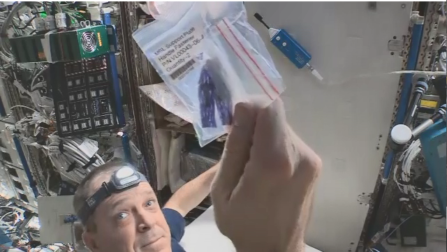 NASA astronaut Ricky Arnold, a space station crew member for Expedition 56, holds up a fastener for the Materials Science Laboratory, which Rhodes packed for shipment to the orbiting laboratory in 2018. “Putting fasteners into foam didn’t take much effort, but what it represented was much bigger: being a small part of an international effort to enable science off the Earth, for the Earth, was an incredible moment I’ll carry with me for the rest of my career.”