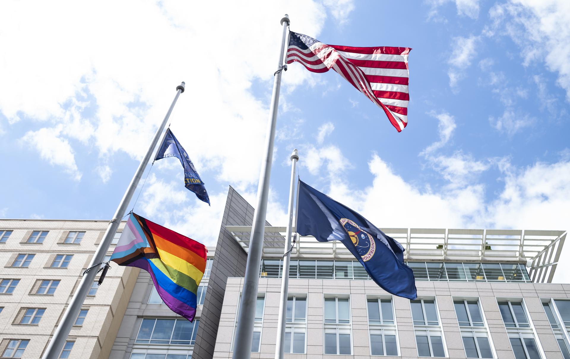 The Progress Pride flag is seen flying at the Mary W. Jackson NASA Headquarters Building, June 9, 2022, in Washington.