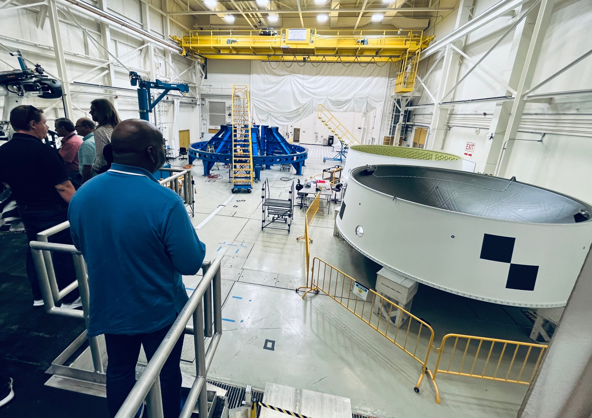 Marshall team members view the Orion Stage Adapters for the Artemis II and Artemis III test flights inside Building 4708. The Orion Stage Adapter, built at Marshall, connects the rocket’s interim cryogenic propulsion stage to the Orion spacecraft. The Orion Stage Adapter for Artemis II is complete and ready to be shipped to Kennedy Space Center. The Oct. 24 tours featured four stops that also included opportunities to see the Artemis III launch vehicle stage adapter, and the development test article for the SLS Block 1B universal stage adapter that will begin flying on Artemis IV. Additionally, programs and offices such as the Human Landing Systems Development Office and the Science and Technology Office hosted exhibits in the lobby of Building 4220, where employees gathered for the tours.