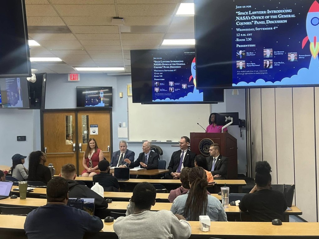 Panel members and audience members are shown during panel discussion