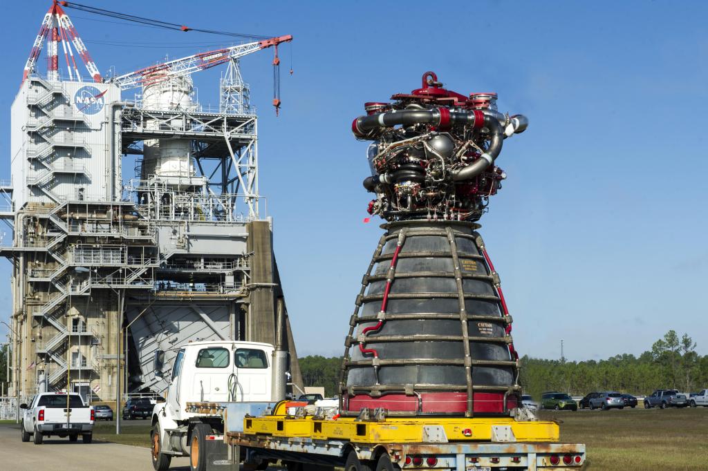 The first RS-25 flight engine, engine No. 2059, sits on a truck bed as it is being delivered to the Fred Haise Test Stand