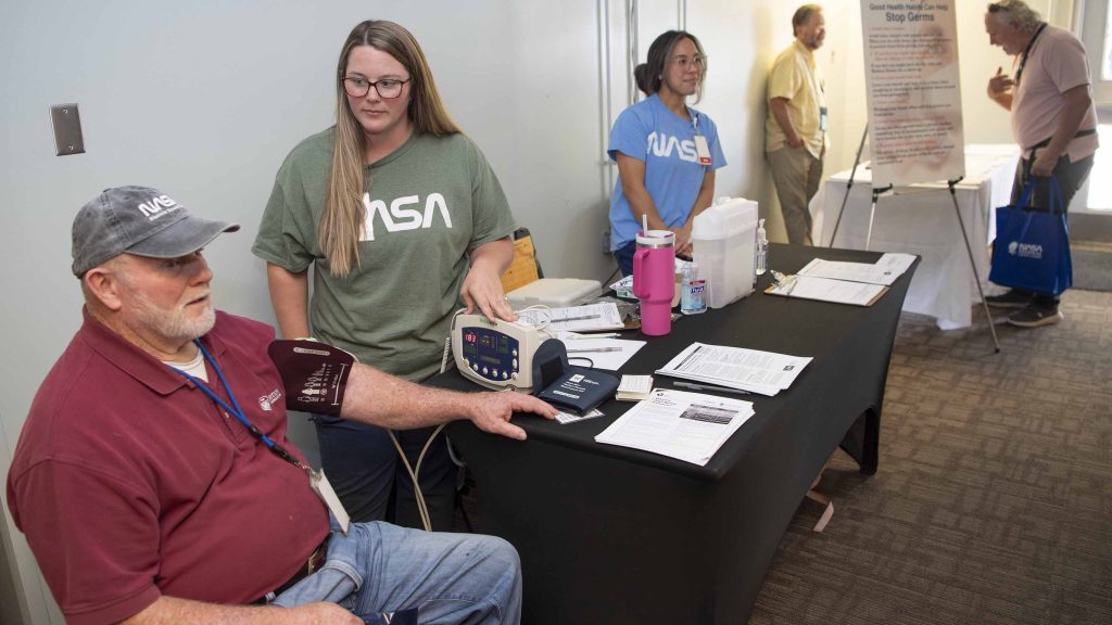 A NASA Stennis employee visits one of the booths during the annual Safety and Health Day in which he receives a complimentary blood pressure check.