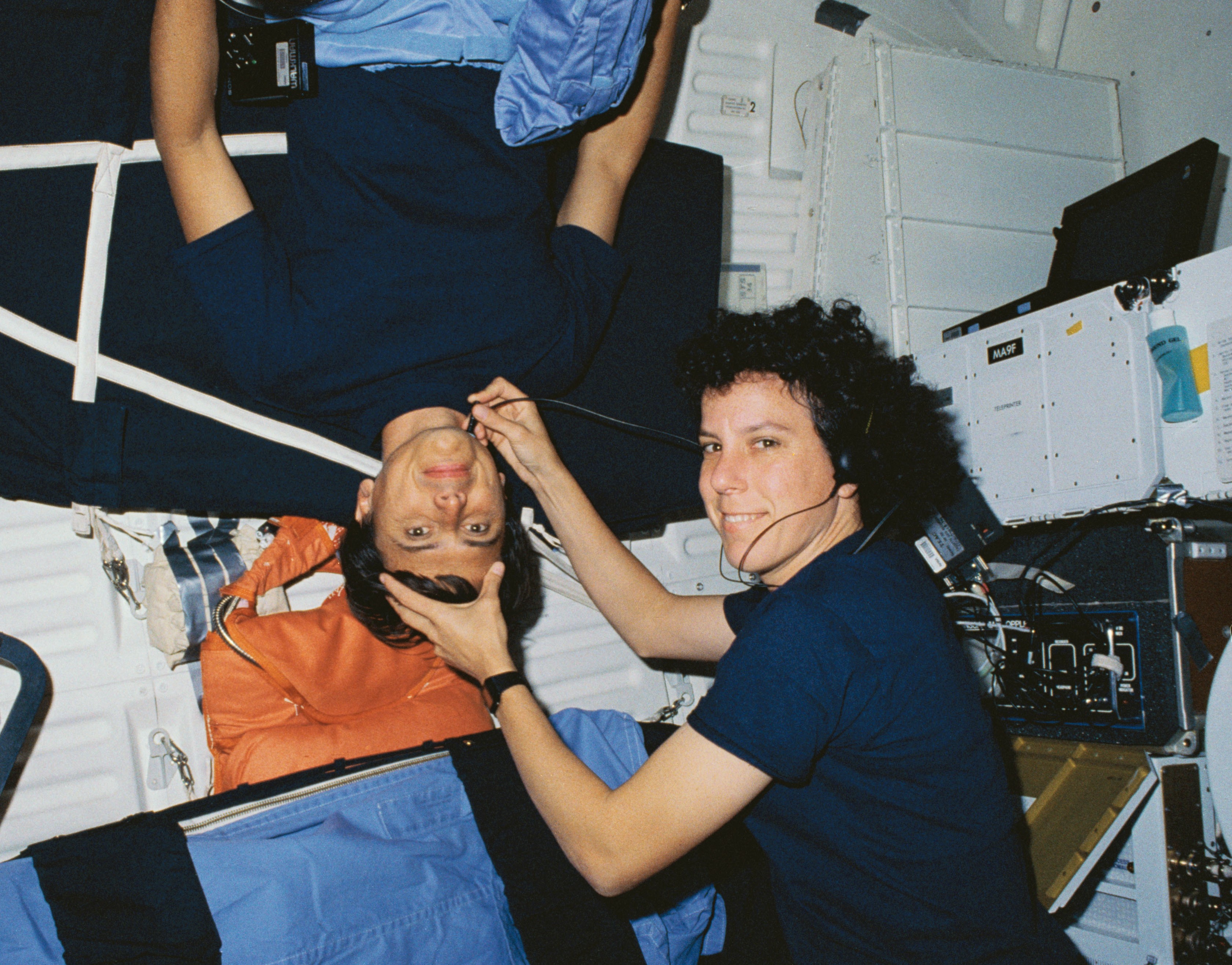 Ellen S. Baker, right, performs a carotid blood flow experiment on Franklin R. Chang-Díaz