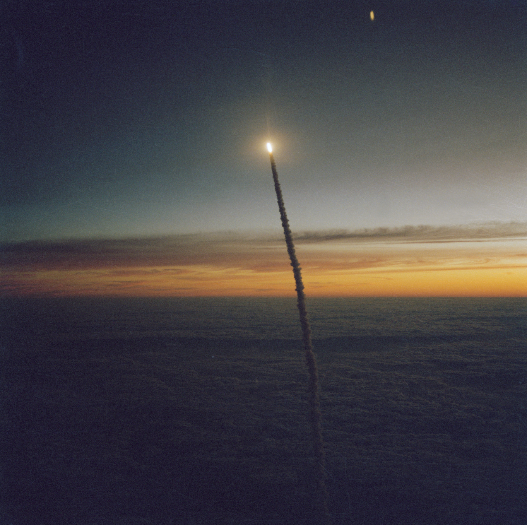 Distant view of Challenger as it rises through the predawn skies