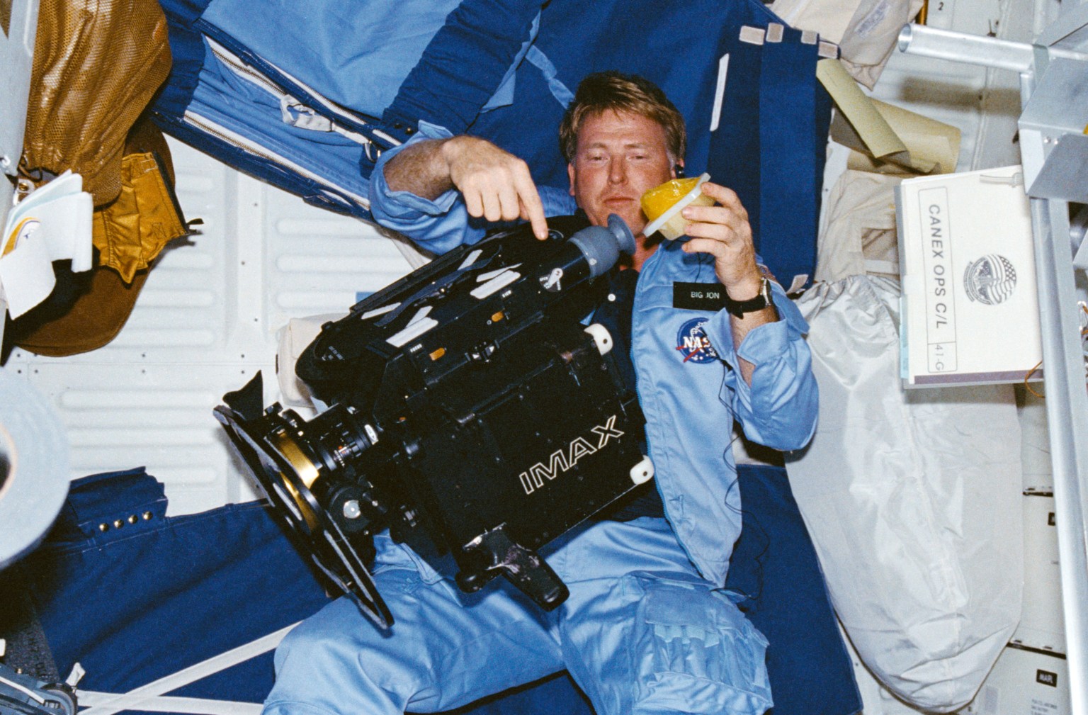 NASA Space Technology Jon A. McBride with the IMAX large format camera in the middeck during the STS-41G mission.