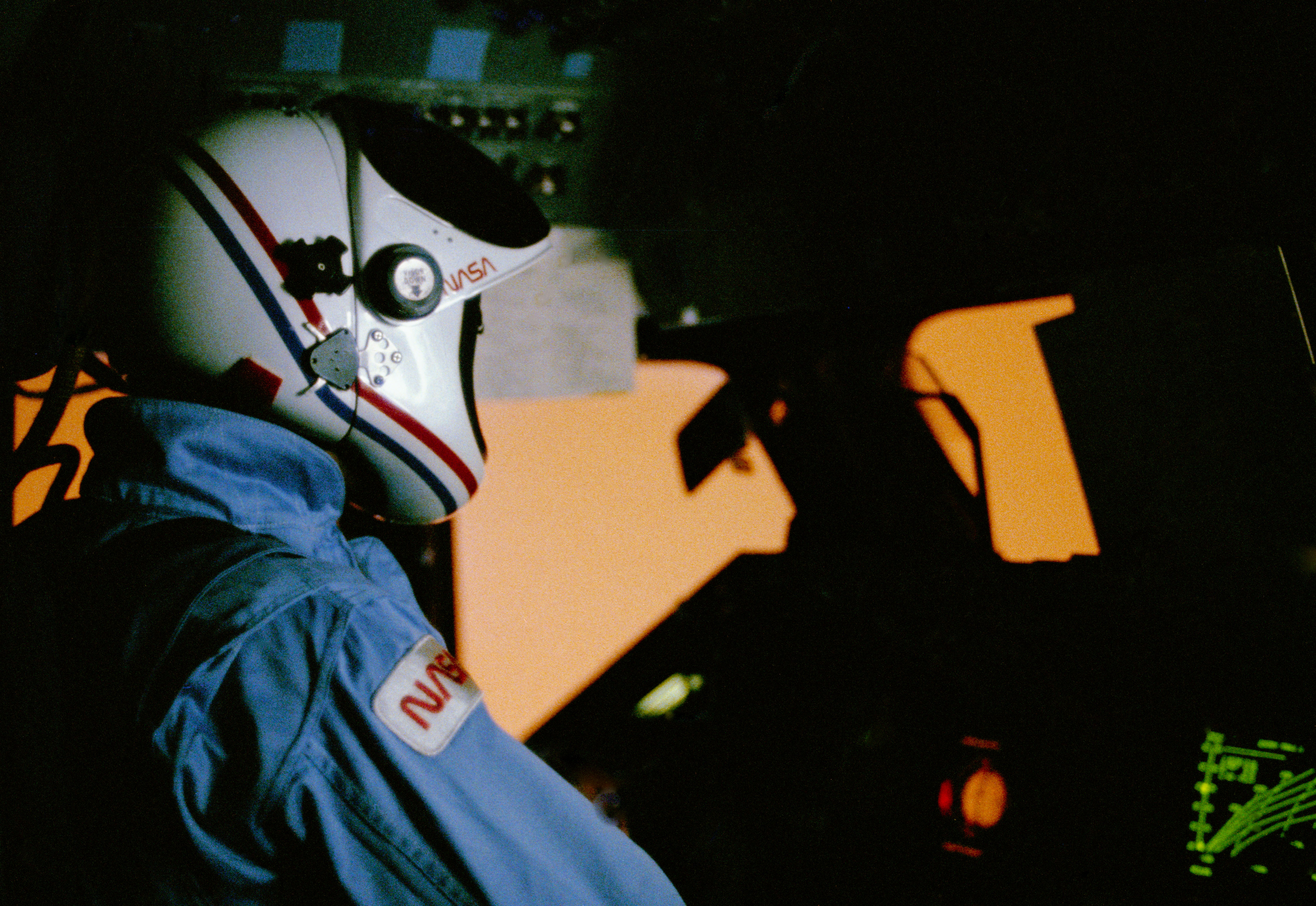 Robert L. Crippen with the orange glow generated outside Challenger during reentry