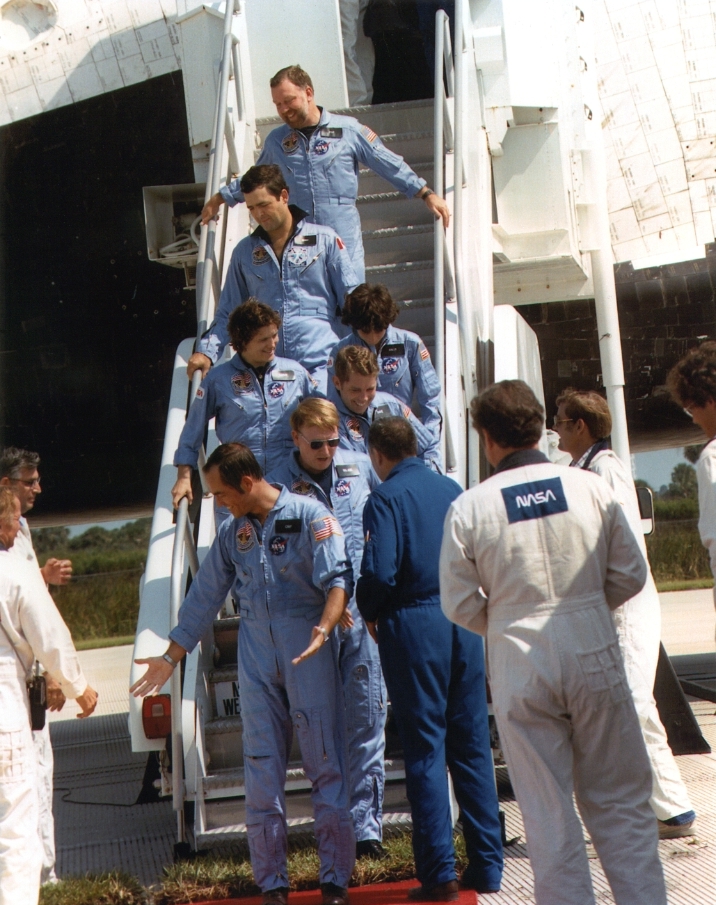 The crew of STS-41G descends from Challenger after completing a highly successful mission