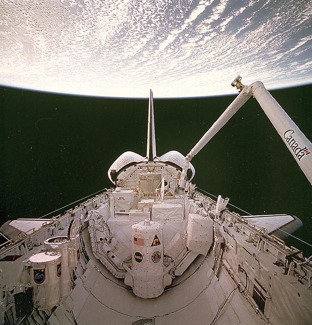 European Space Agency astronaut Jean-François Clervoy uses the shuttle's Remote Manipulator System (RMS) to grapple the CRISTA-SPAS prior to its release