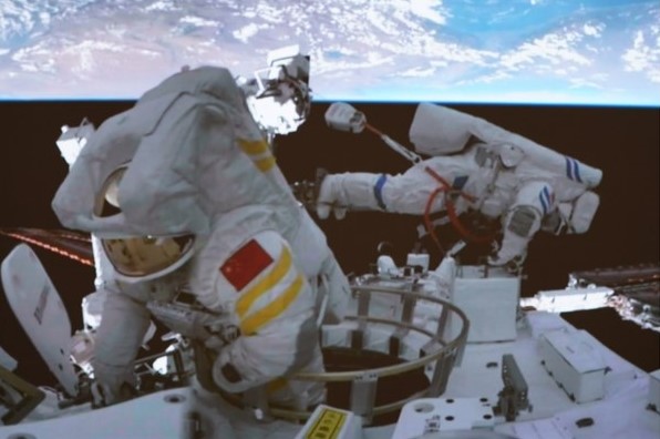 Chinese astronaut Liu Yang, left, during her spacewalk from the Tiangong space station