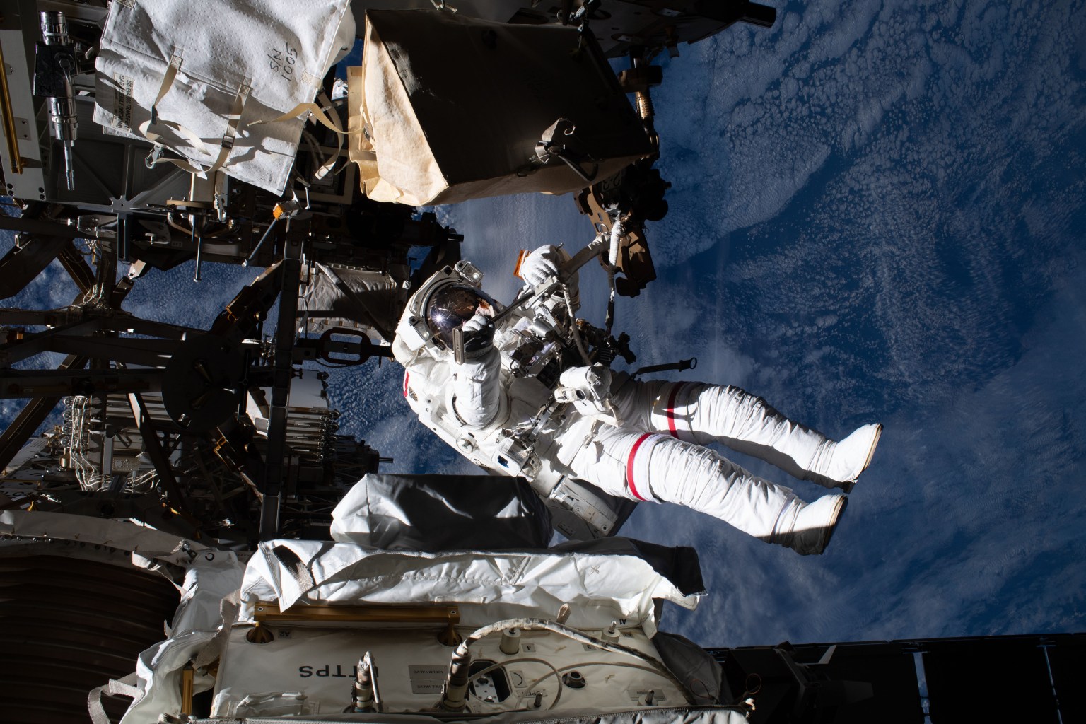 NASA astronaut Andrew Morgan is pictured tethered to the International Space Station while finalizing thermal repairs on the Alpha Magnetic Spectrometer, a dark matter and antimatter detector, during a spacewalk that lasted 6 hours and 16 minutes.