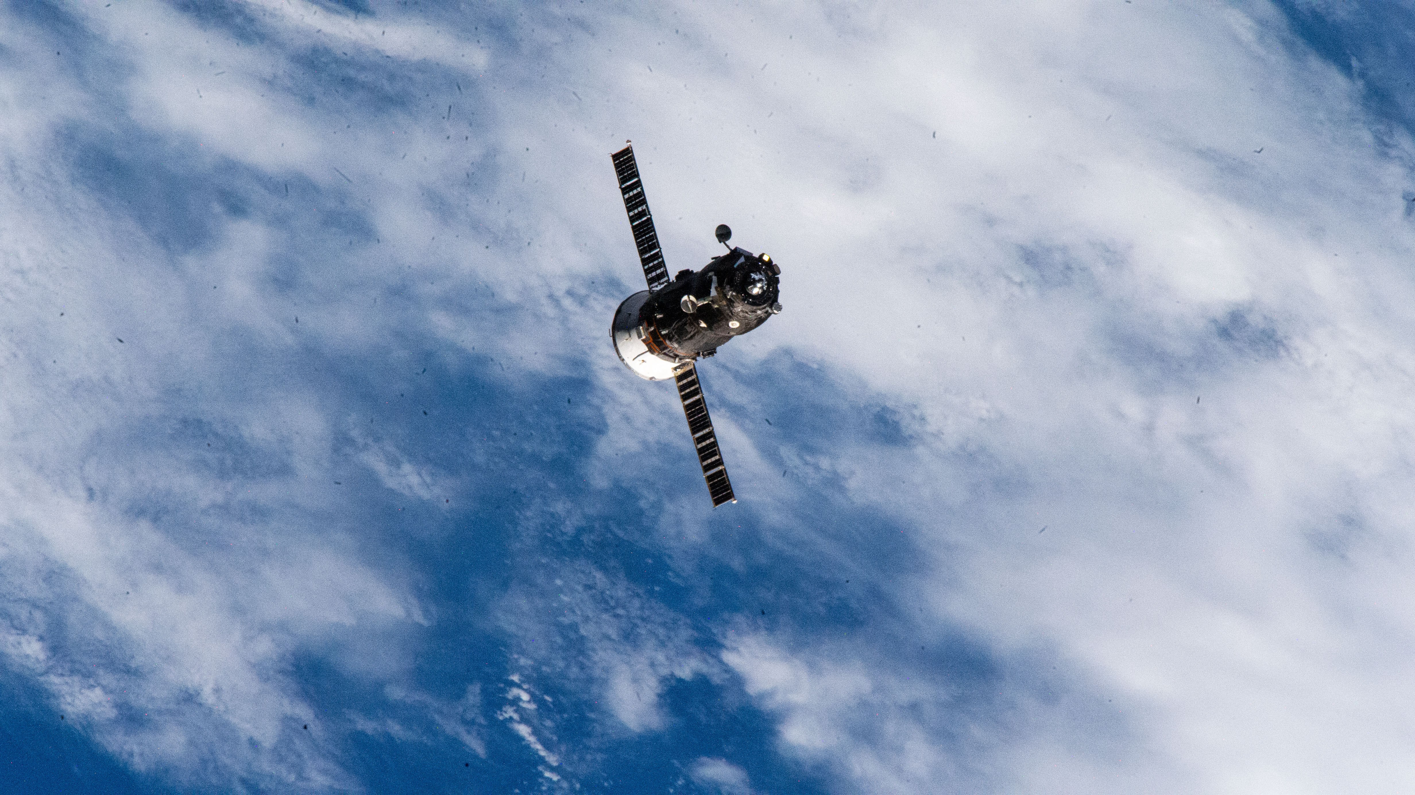 A Progress spacecraft is pictured from the International Space Station as it orbited 257 miles above a cloudy pacific ocean. 