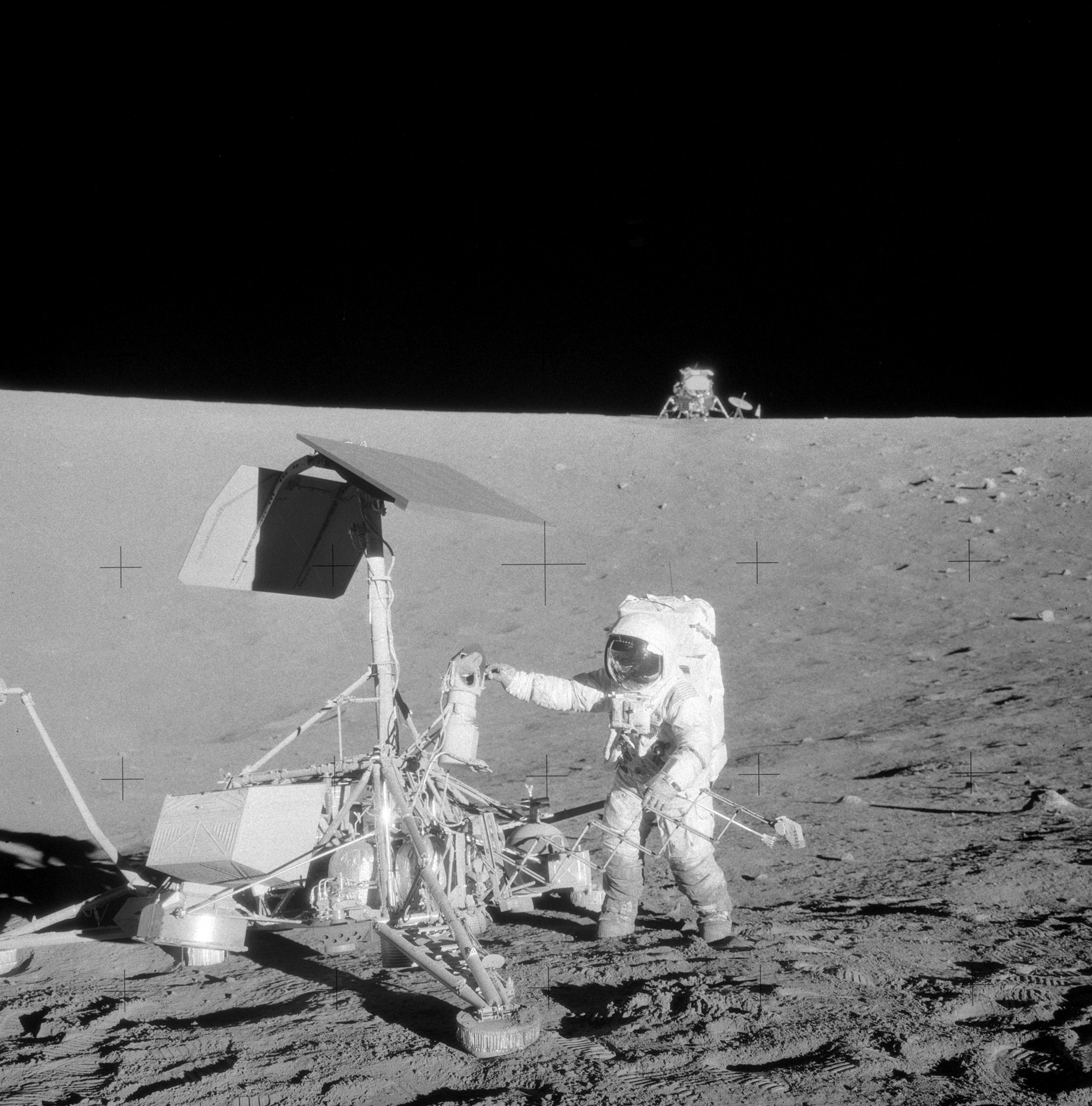 Charles “Pete” Conrad with the Surveyor 3 spacecraft, with their Lunar Module (LM) Intrepid visible in the background