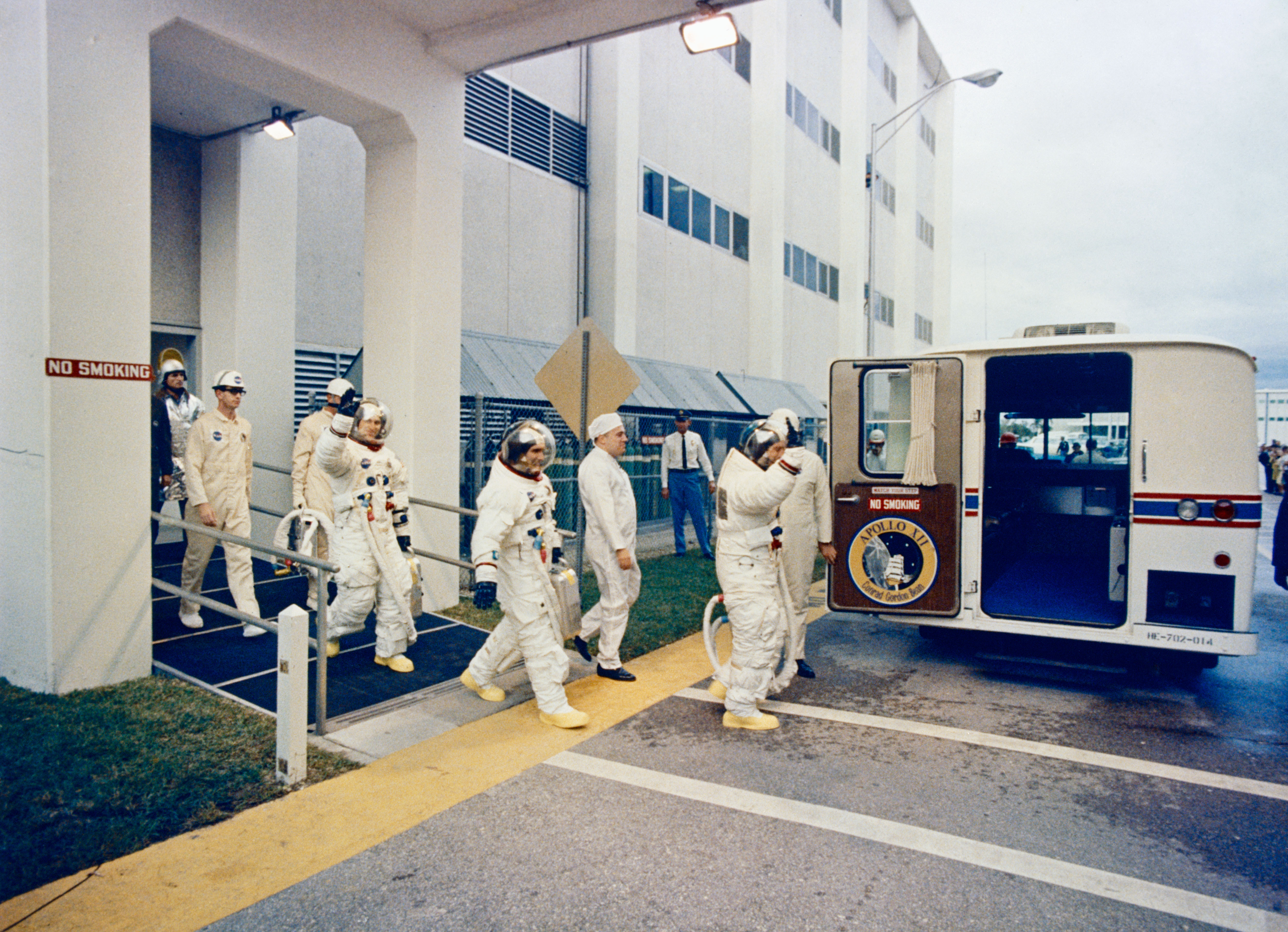 Astronauts Conrad leads Gordon and Bean onto the astronaut van