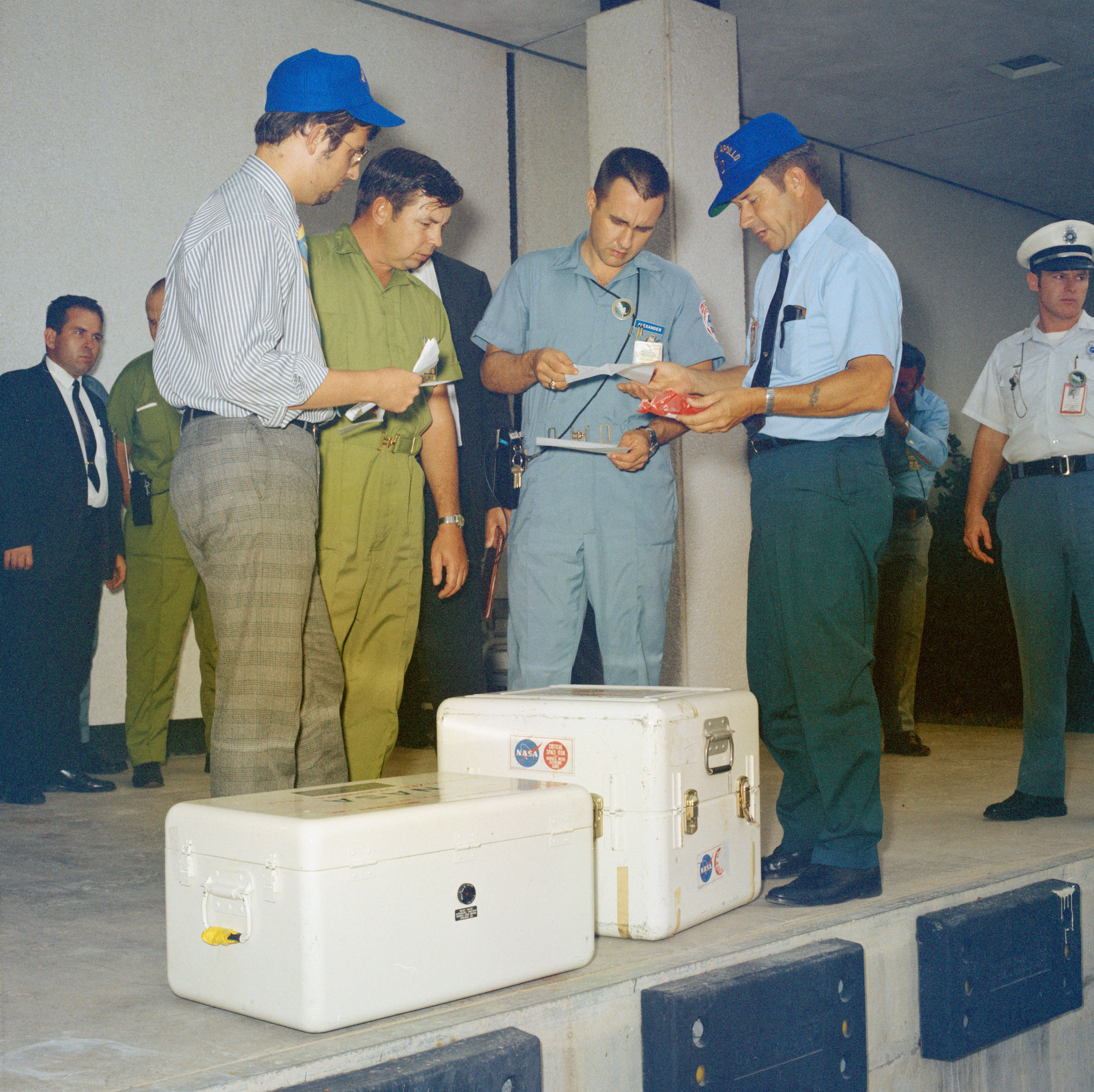 Technicians log in the first set of Apollo 12 lunar samples and film at the Lunar Receiving Laboratory’s (LRL) loading dock