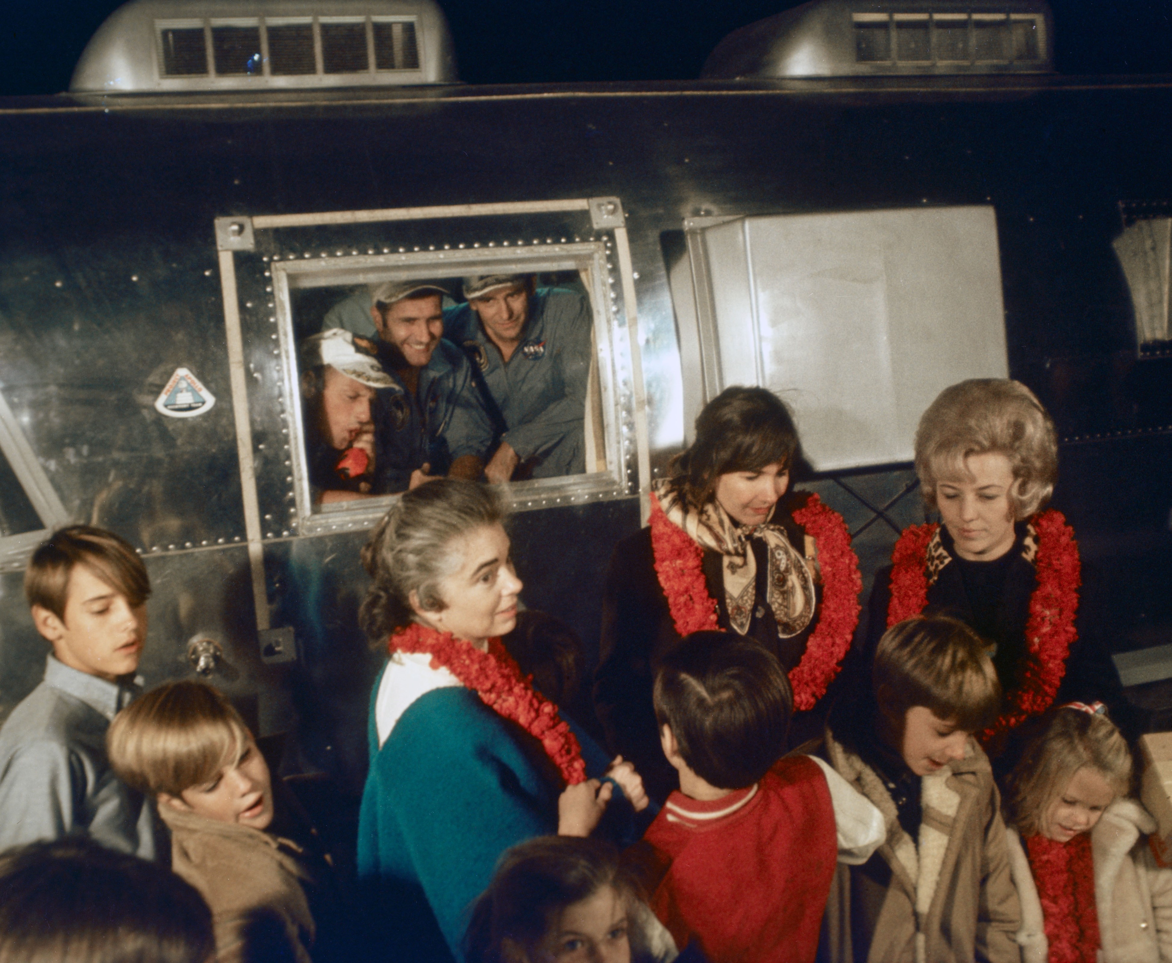 The Apollo 12 astronauts' wives Barbara Gordon, left, Jane Conrad, and Sue Bean and their children welcome their husbands home