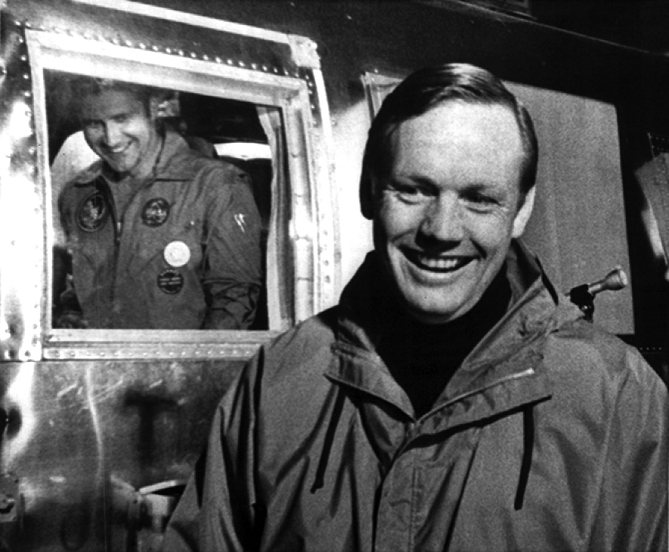 Apollo 11 astronaut Neil A. Armstrong greets the Apollo 12 crew upon their return to Ellington