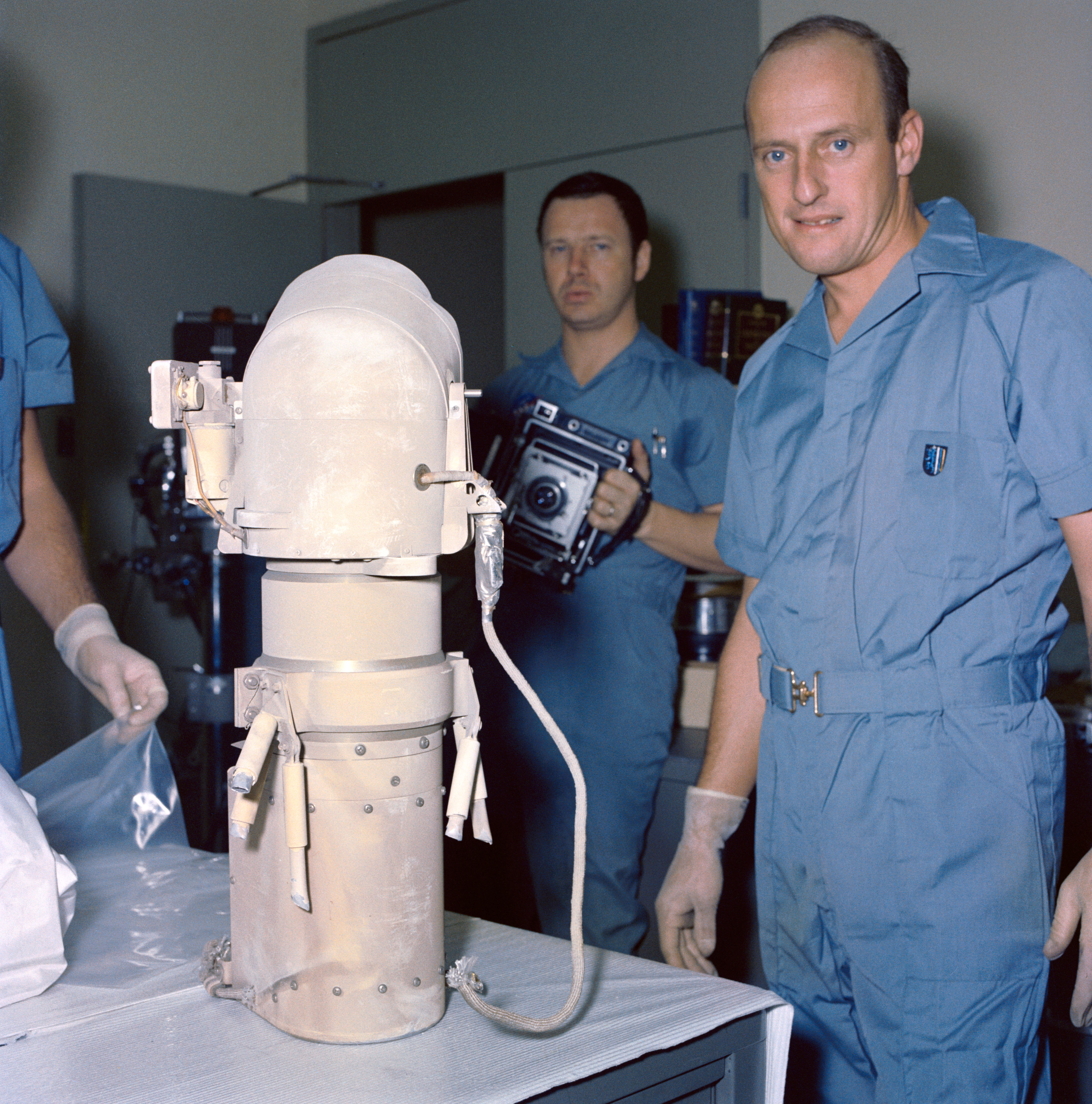 Conrad examines the camera from Surveyor 3 that he and Bean returned from the Moon