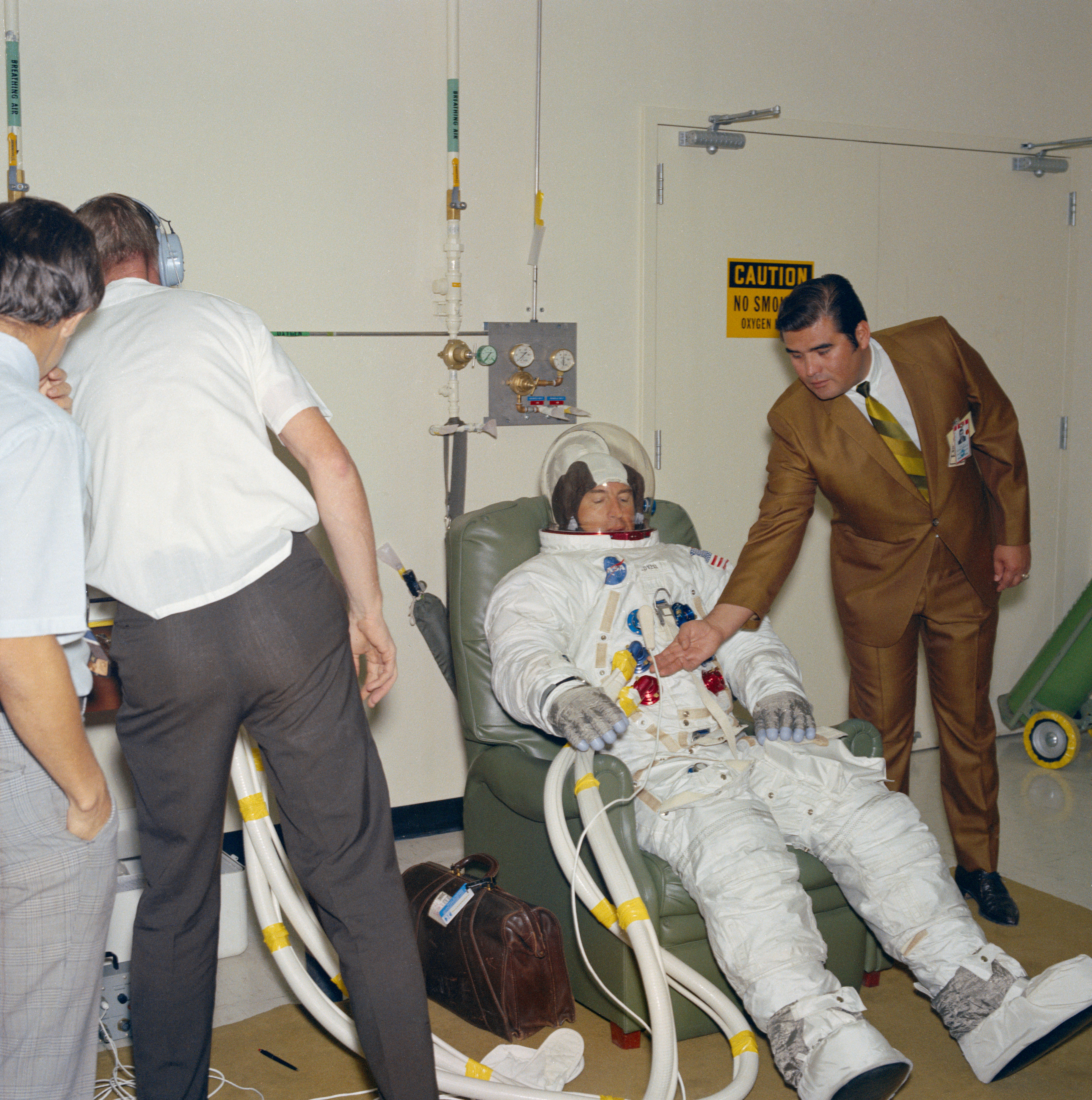 Apollo 13 astronaut James A. Lovell preparing to test his spacesuit in a vacuum chamber in the Space Environment Simulation Laboratory at the Manned Spacecraft Center