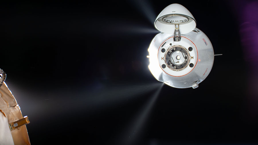 Thrusters on the SpaceX Dragon cargo spacecraft fire adjusting the vehicle's approach toward the station for a docking to the Harmony module's forward port.