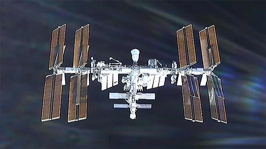 The International Space Station is viewed from a camera aboard the approaching SpaceX Dragon cargo spacecraft. The SpaceX Dragon Freedom crew spacecraft is pictured (at center) docked to the Harmony module's space-facing port. Credit: NASA+