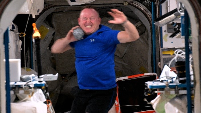 NASA astronaut Butch Wilmore throws the shot put during the ISS Olympics.