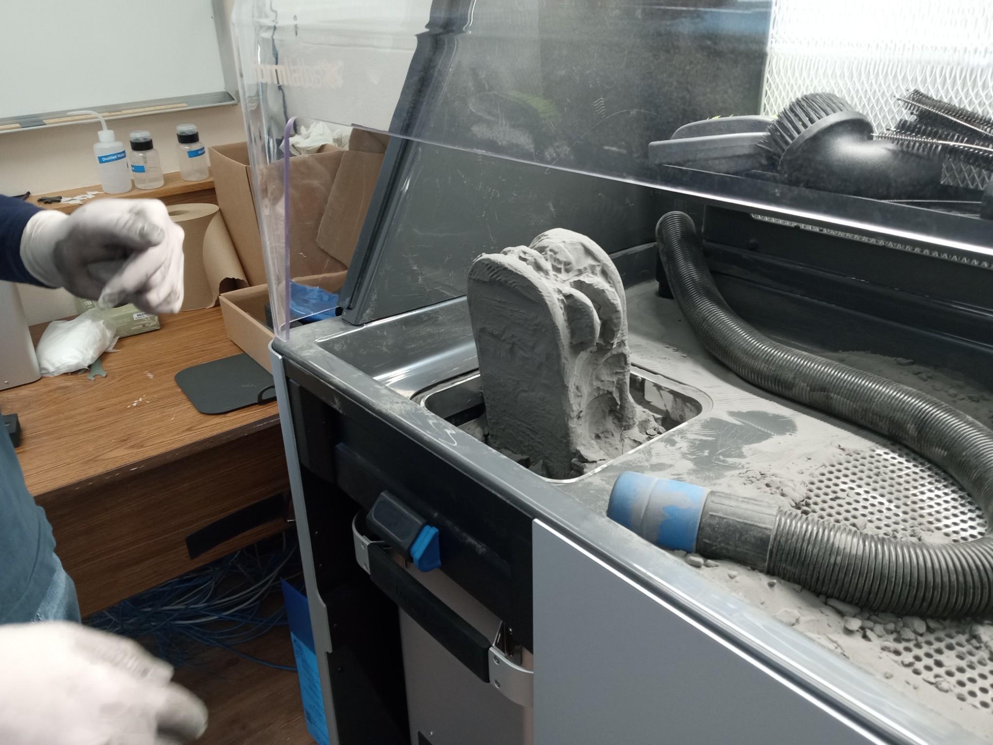 3D printing machine using a gray powder substance.