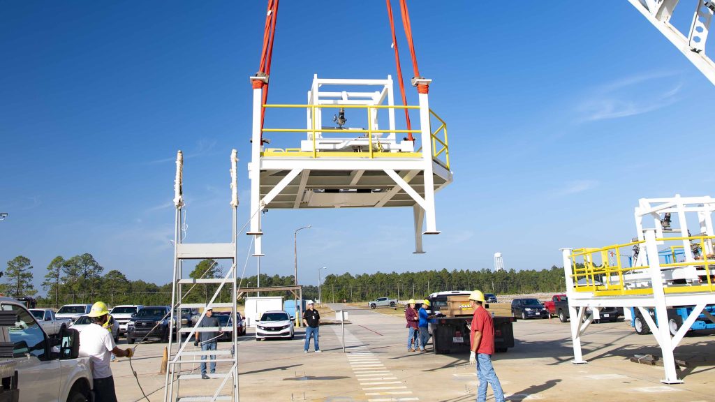 A pair of umbilical support structures needed for future testing of NASA’s exploration upper stage (EUS) are shown suspended in air