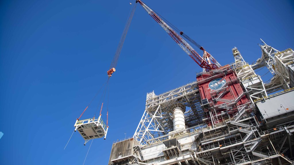 A pair of umbilical support structures needed for future testing of NASA’s exploration upper stage (EUS) are shown suspended in air