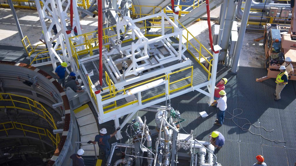 crew members working to secure the umbilical support structures in place