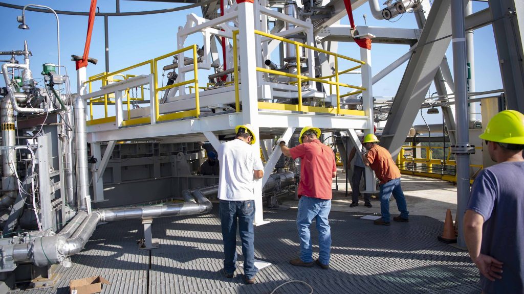 crew members working to secure the umbilical support structures in place