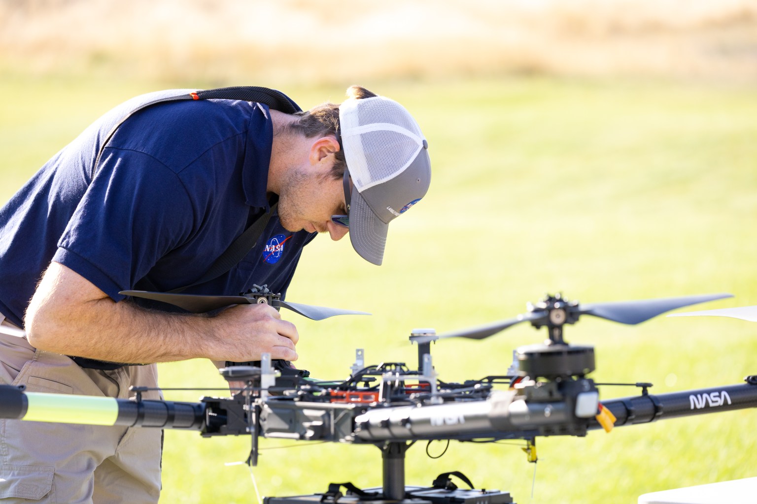 Brayden Chamberlain, UAS Pilot in Command, performs pre-flight checks on the NASA Alta X uncrewed aerial system (UAS) during NASA FireSense’s uncrewed aerial system (UAS) technology demonstration in Missoula, Montana.