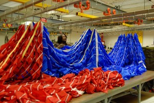 A worker at NASA's Kennedy Space Center hangs portions of a parachute in preparation for an upcoming test at the Parachute Refurbishment Facility. The first stage of the new Ares I rocket and Orion spacecraft will use parachutes to return to Earth. Current tests are being performed in Arizona to make sure the designs can safely handle their intended weight. Credit: NASA/Kim Shiflett