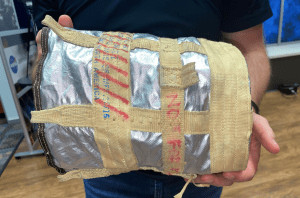 4)The outside of a Forward Bay Cover Parachute (FBCP) deployment bag. Aluminized Kelvar is used to protect against the pyrotechnic deployment from the mortars, and the Kevlar webbing provides further structural integrity. Credit: Courtney Beasley/Jared Daum