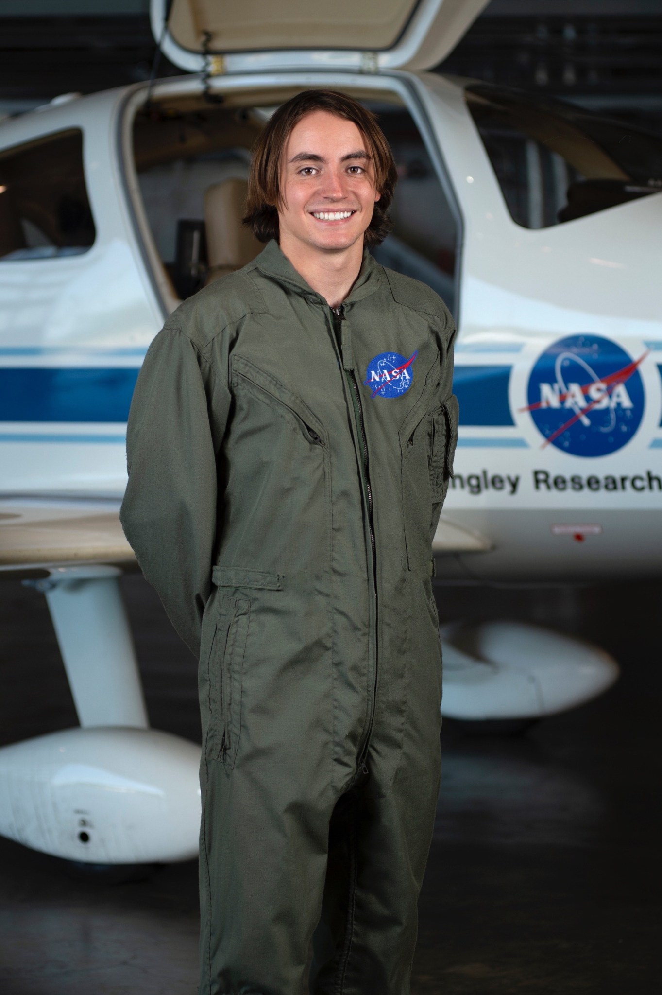 Christopher Davami standing in front of aircraft.